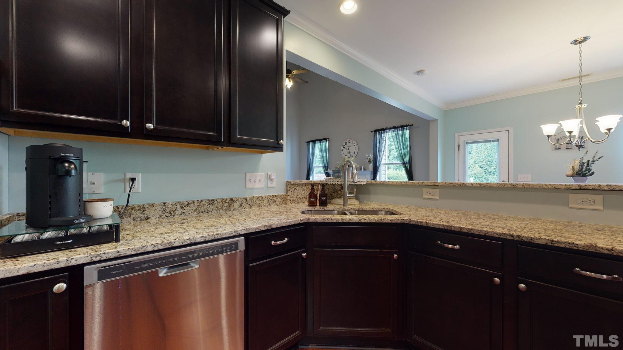 3558 Eastern Branch Road Raleigh, NC 27610 - Photo 17 of 25 a kitchen with granite countertop stainless steel appliances a sink stove and cabinets