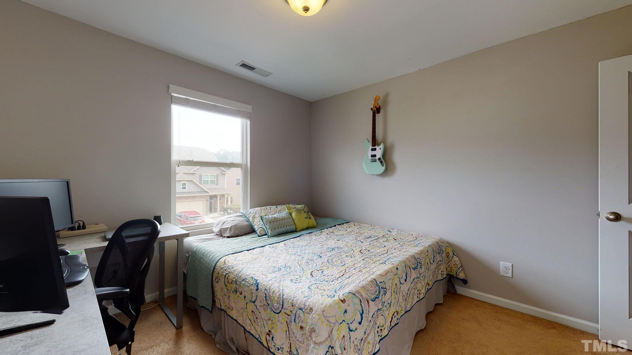3558 Eastern Branch Road Raleigh, NC 27610 - Photo 24 of 25 a bedroom with a bed and a window