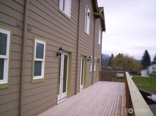 a view of backyard with a deck and wooden floor