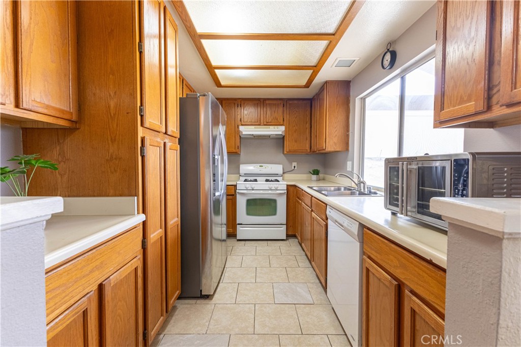 42015 Cosmic Drive Temecula, CA 92592 - Photo 6 of 27 a kitchen with stainless steel appliances granite countertop a sink stove and cabinets