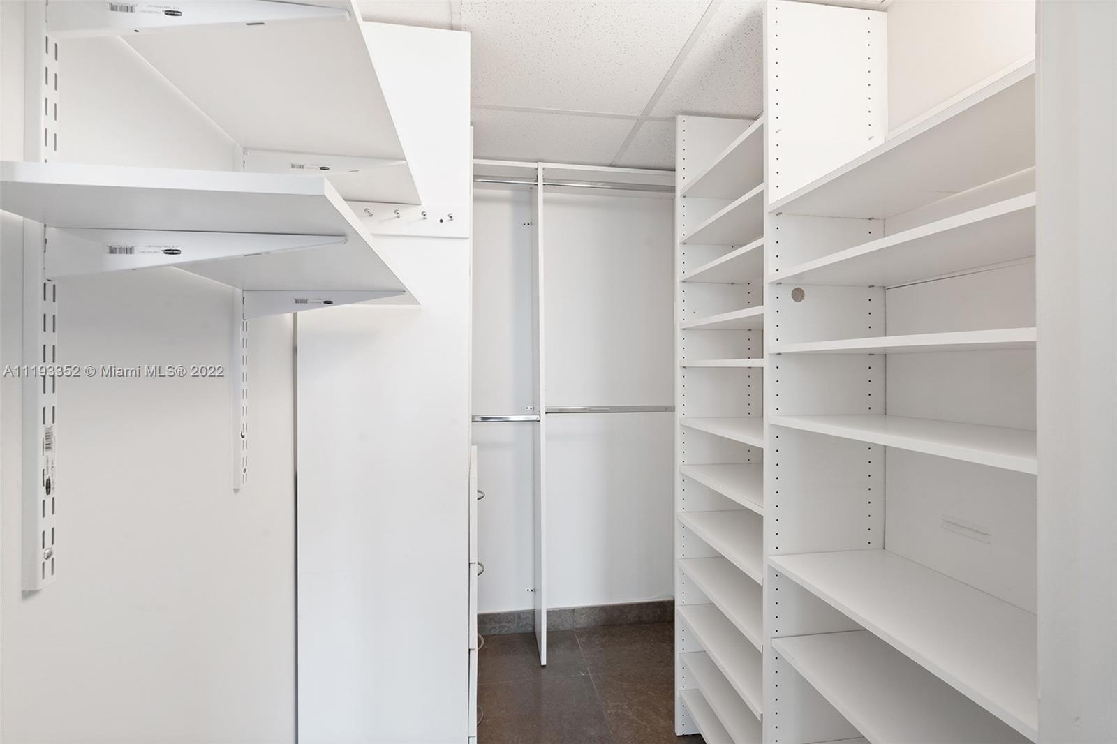 465 Brickell Avenue, Unit 2604 Miami, FL 33131 - Photo 13 of 23 a view of walk in closet with empty racks