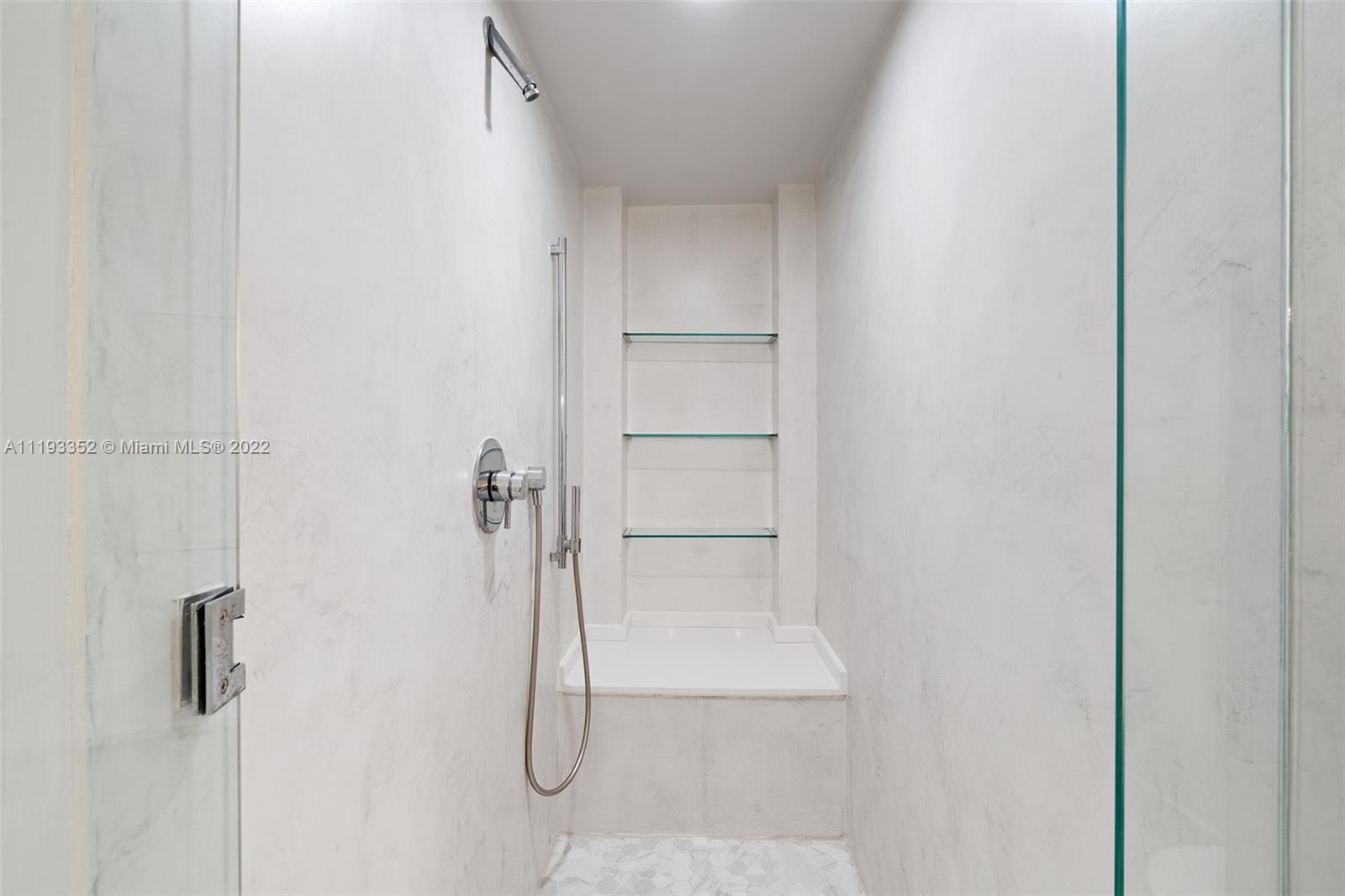 465 Brickell Avenue, Unit 2604 Miami, FL 33131 - Photo 15 of 23 a bathroom with a glass shower door