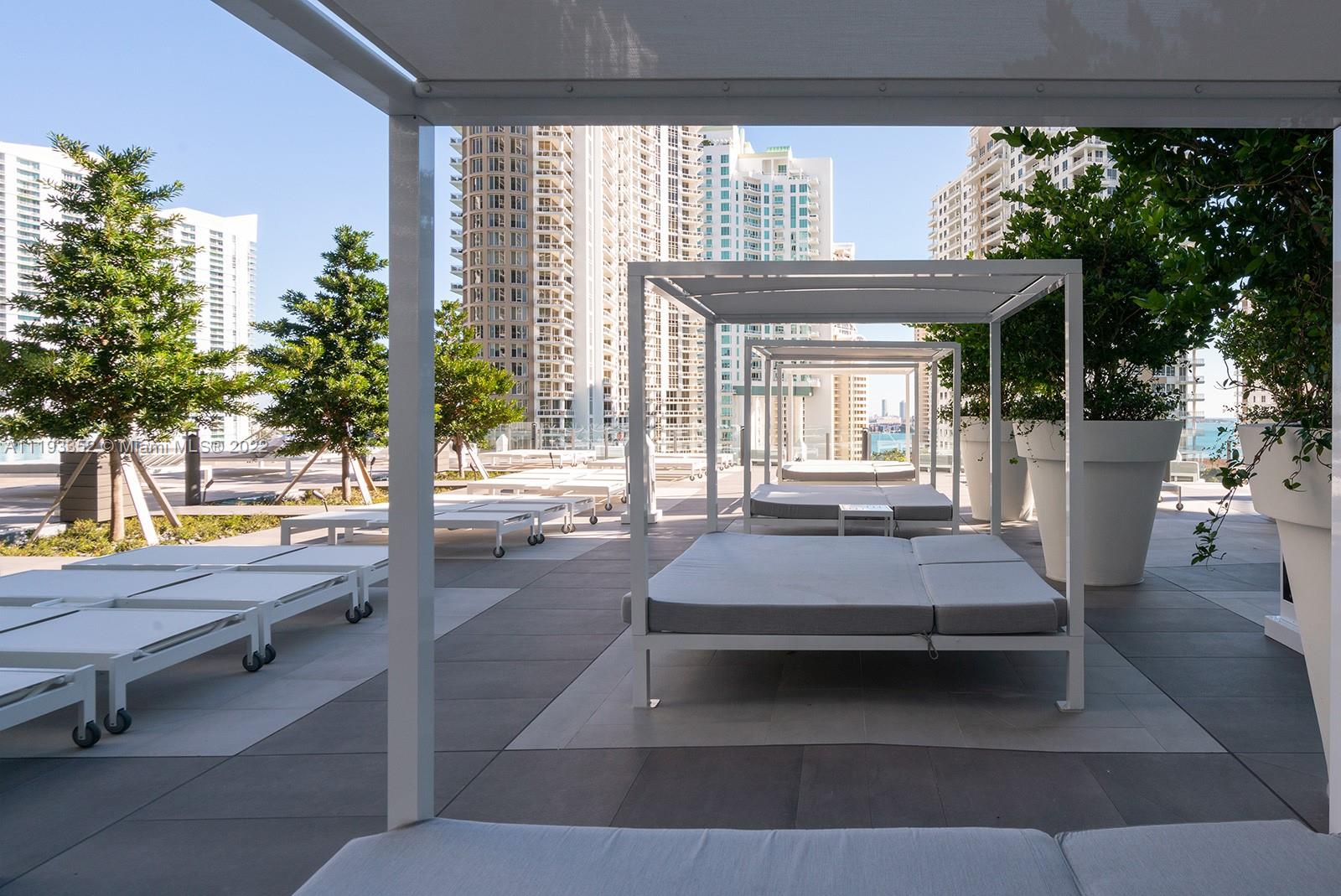 465 Brickell Avenue, Unit 2604 Miami, FL 33131 - Photo 19 of 23 a living room with patio furniture and a potted plant