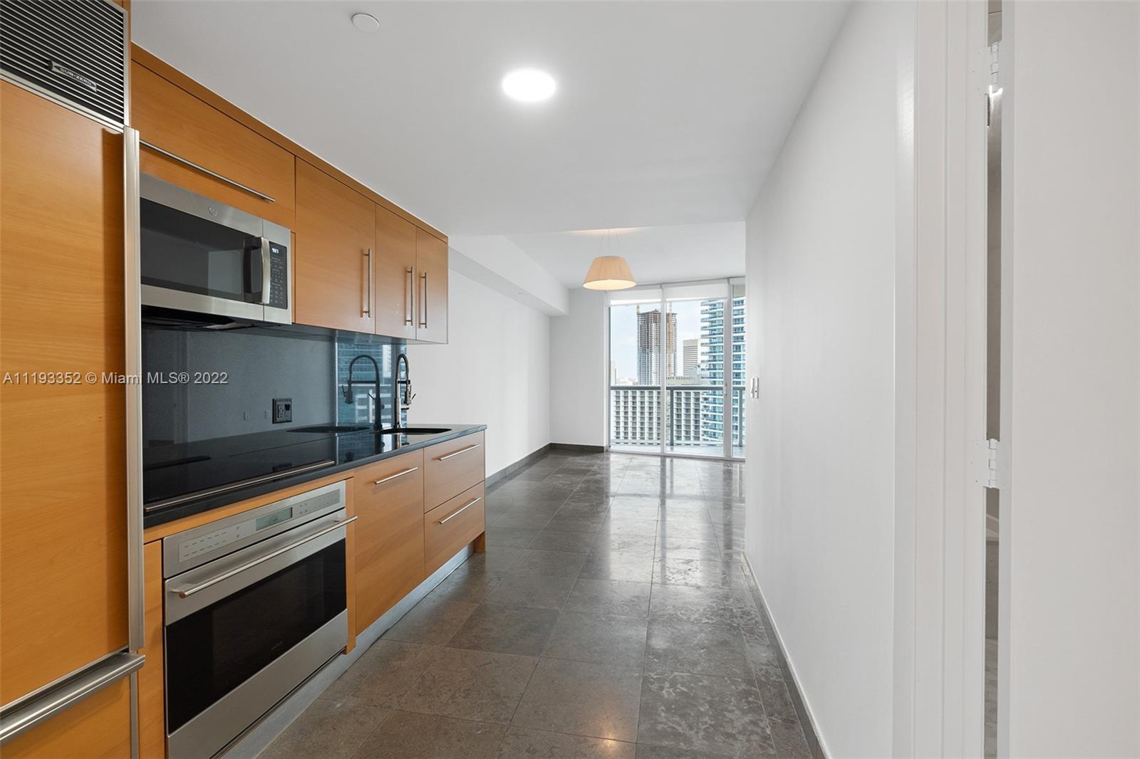 465 Brickell Avenue, Unit 2604 Miami, FL 33131 - Photo 5 of 23 a kitchen with stainless steel appliances granite countertop a stove and a refrigerator