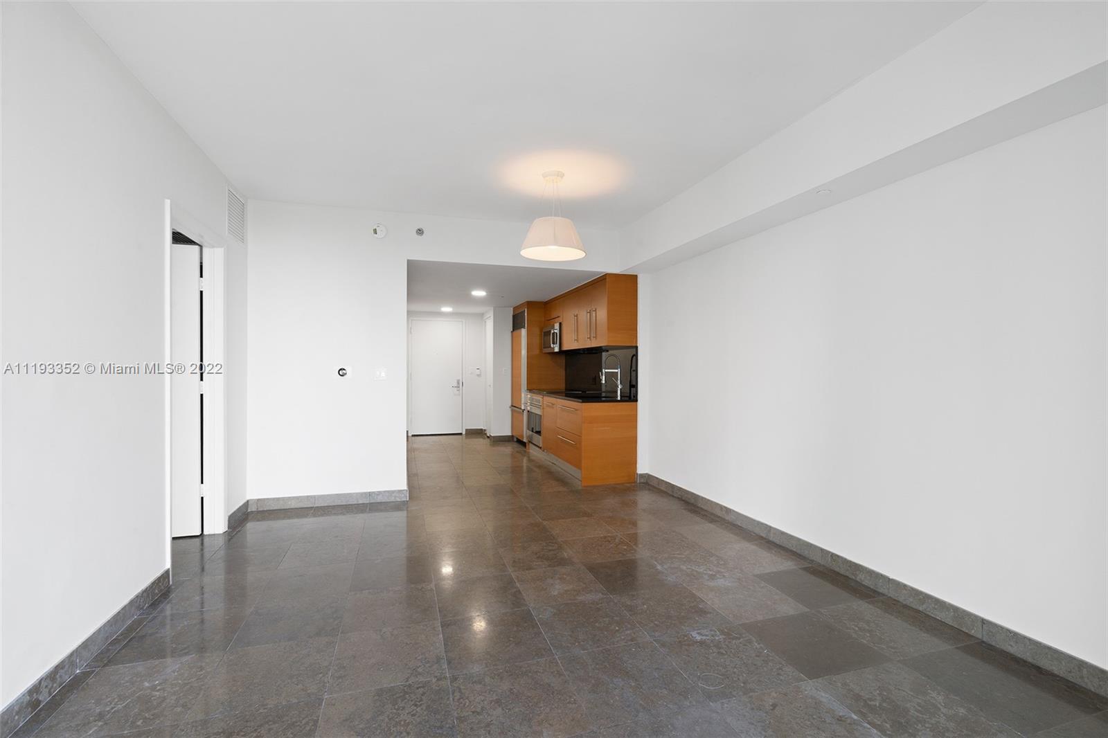 465 Brickell Avenue, Unit 2604 Miami, FL 33131 - Photo 8 of 23 a view of a kitchen with a sink and a refrigerator