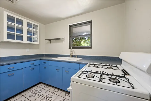 a kitchen with a cabinets and white appliances