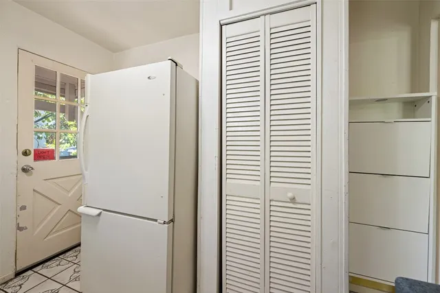 a white refrigerator freezer and a window