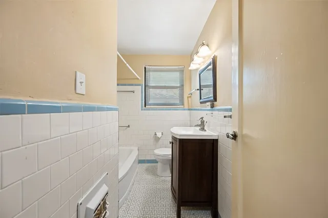 a bathroom with a sink a toilet and mirror