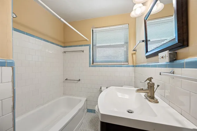 a bathroom with a sink a toilet and bathtub