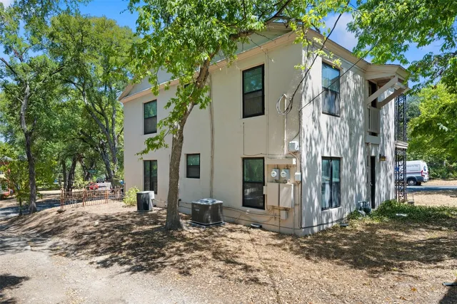 a view of a house with a tree in the background
