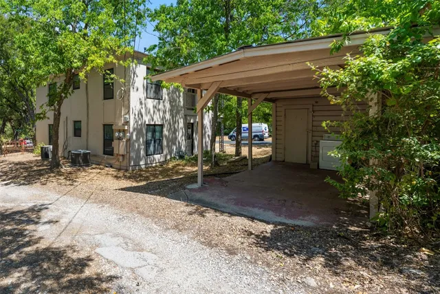 a view of a patio with table and chairs under an umbrella
