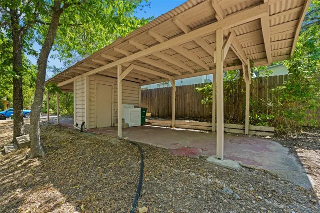 a backyard of a house with table and chairs