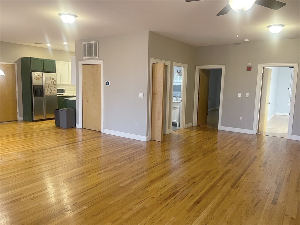 877 Harrison Avenue, Unit 6 Boston, MA 02118 - Photo 5 of 9 a view of a hallway with wooden floor
