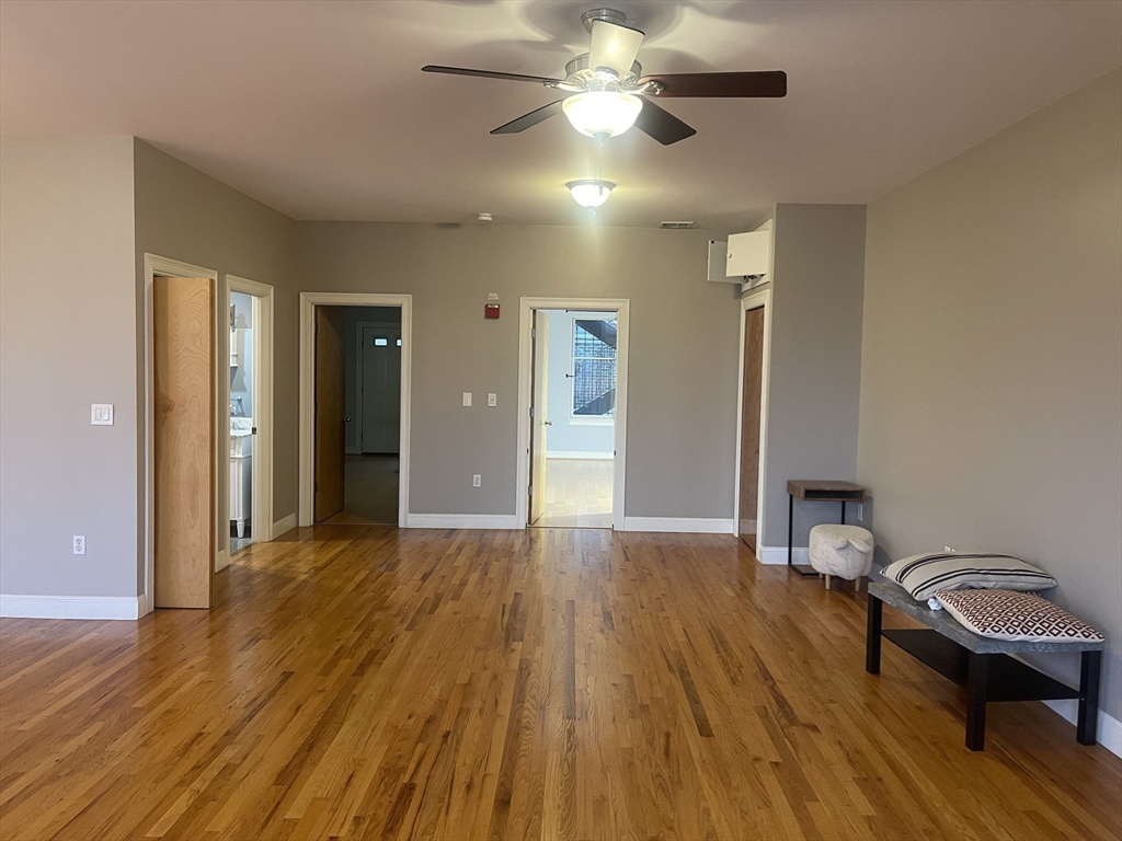 877 Harrison Avenue, Unit 6 Boston, MA 02118 - Photo 6 of 9 a view of a livingroom with furniture and wooden floor