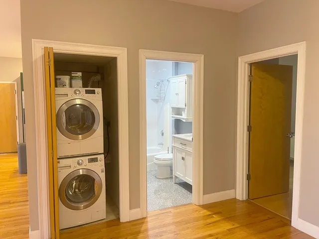 a view of a hallway with washer and dryer