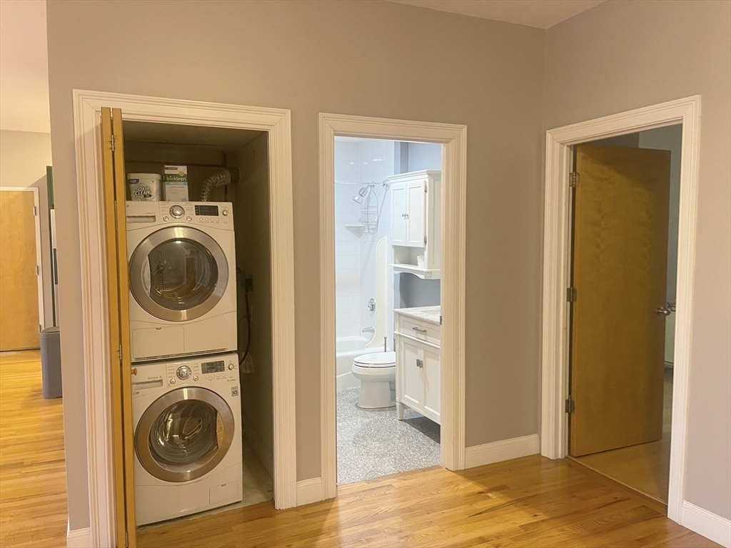 877 Harrison Avenue, Unit 6 Boston, MA 02118 - Photo 7 of 9 a view of a hallway with washer and dryer