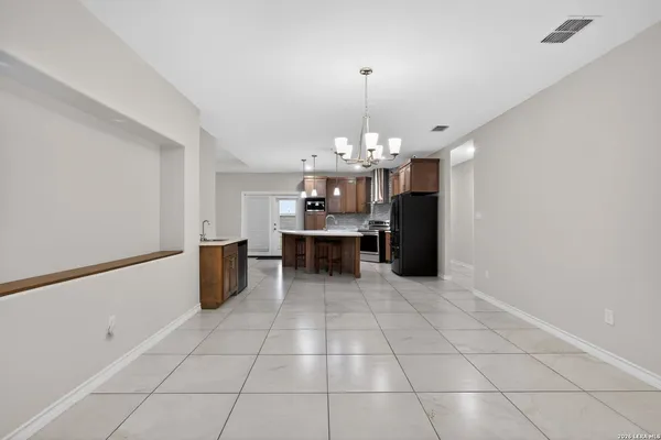 a view of a kitchen with a sink and chandelier