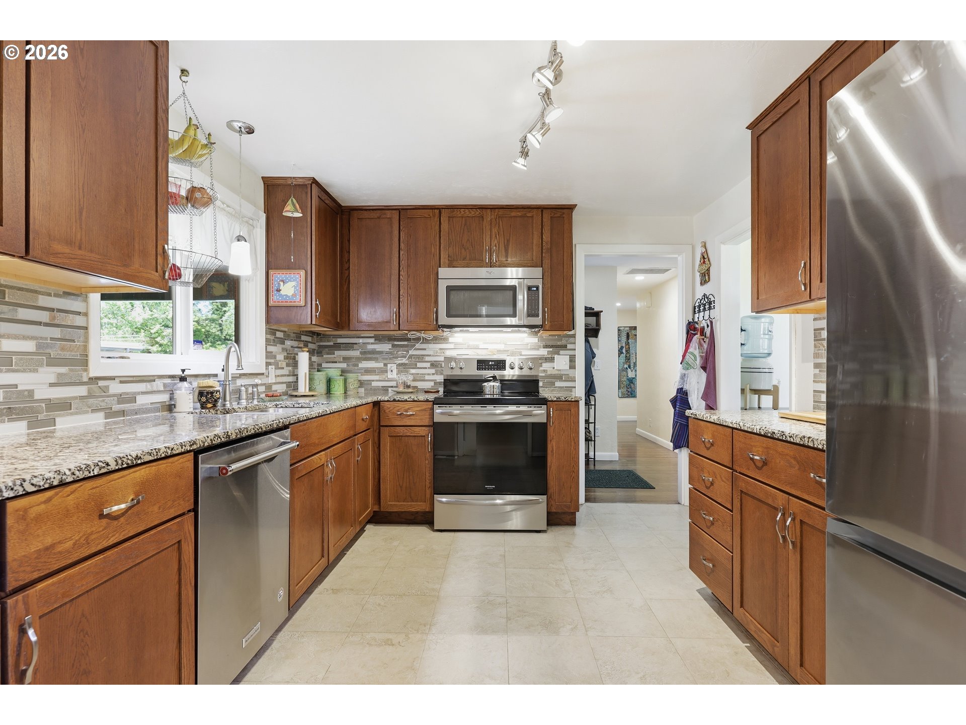 65 Greenvale Drive Springfield, OR 97477 - Photo 14 of 42 a kitchen with stainless steel appliances granite countertop a stove top oven a sink and dishwasher