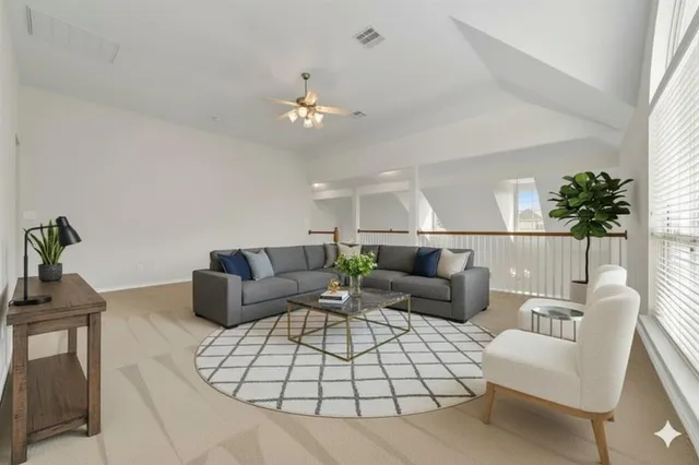 a living room with furniture a chandelier and a potted plant