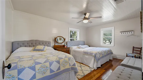 a bedroom with double bed and a chandelier