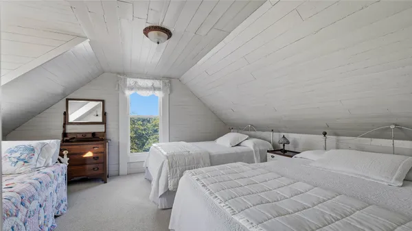 a bedroom with two beds and a large window