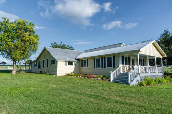 a front view of house with yard and green space