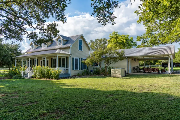 a view of a house with a yard porch and sitting area