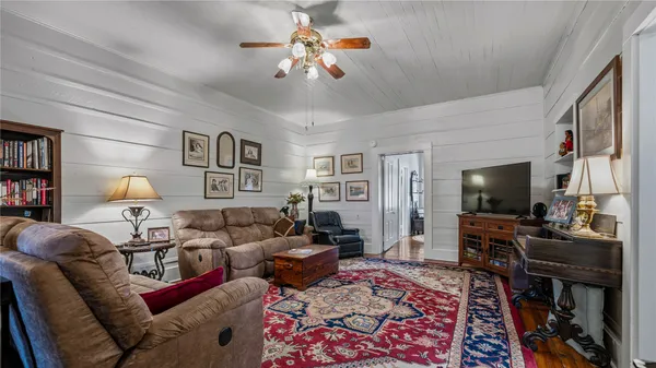 a living room with furniture and a flat screen tv
