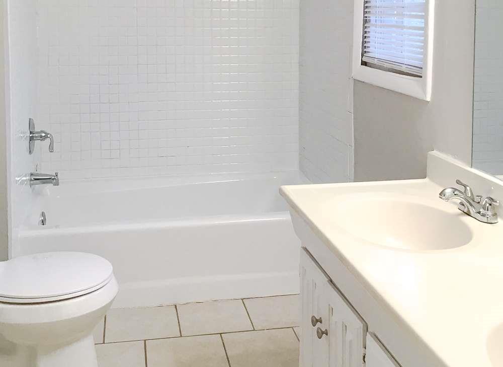 4666 Edwina Lane Southwest Atlanta, GA 30331 - Photo 14 of 15 a bathroom with a sink a toilet and bathtub