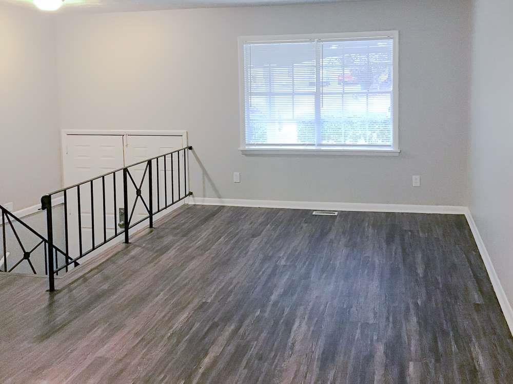 4666 Edwina Lane Southwest Atlanta, GA 30331 - Photo 4 of 15 an empty room with wooden floor and windows