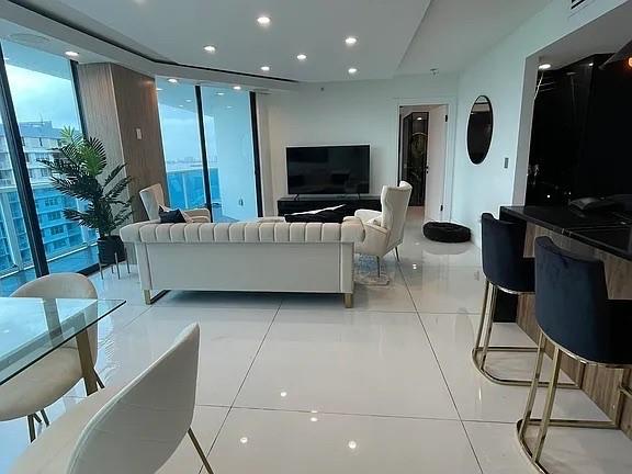 a living room with furniture and a flat screen tv