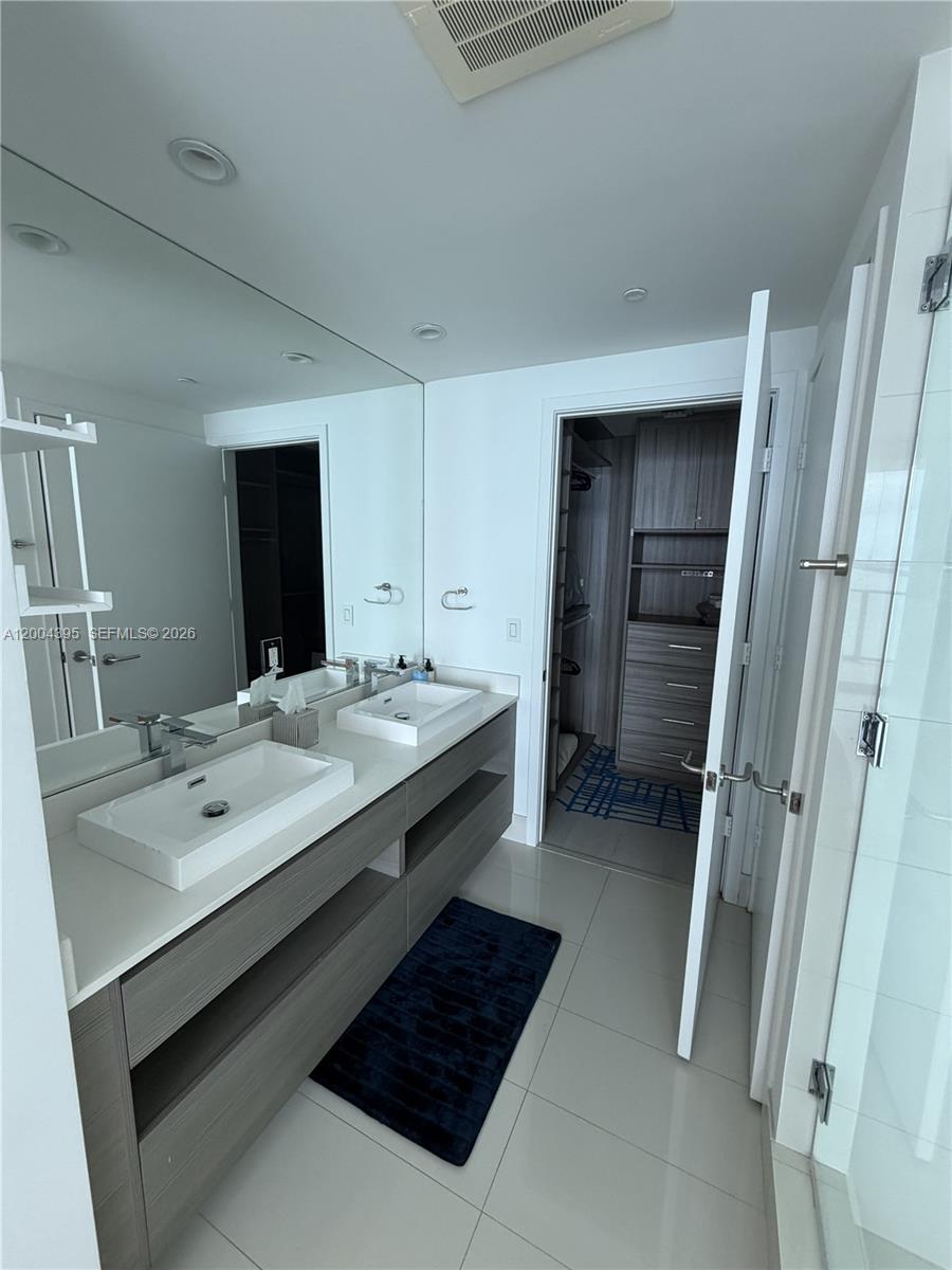 460 Northeast 28th Street, Unit 2806 Miami, FL 33137 - Photo 6 of 10 a bathroom with a sink and a mirror