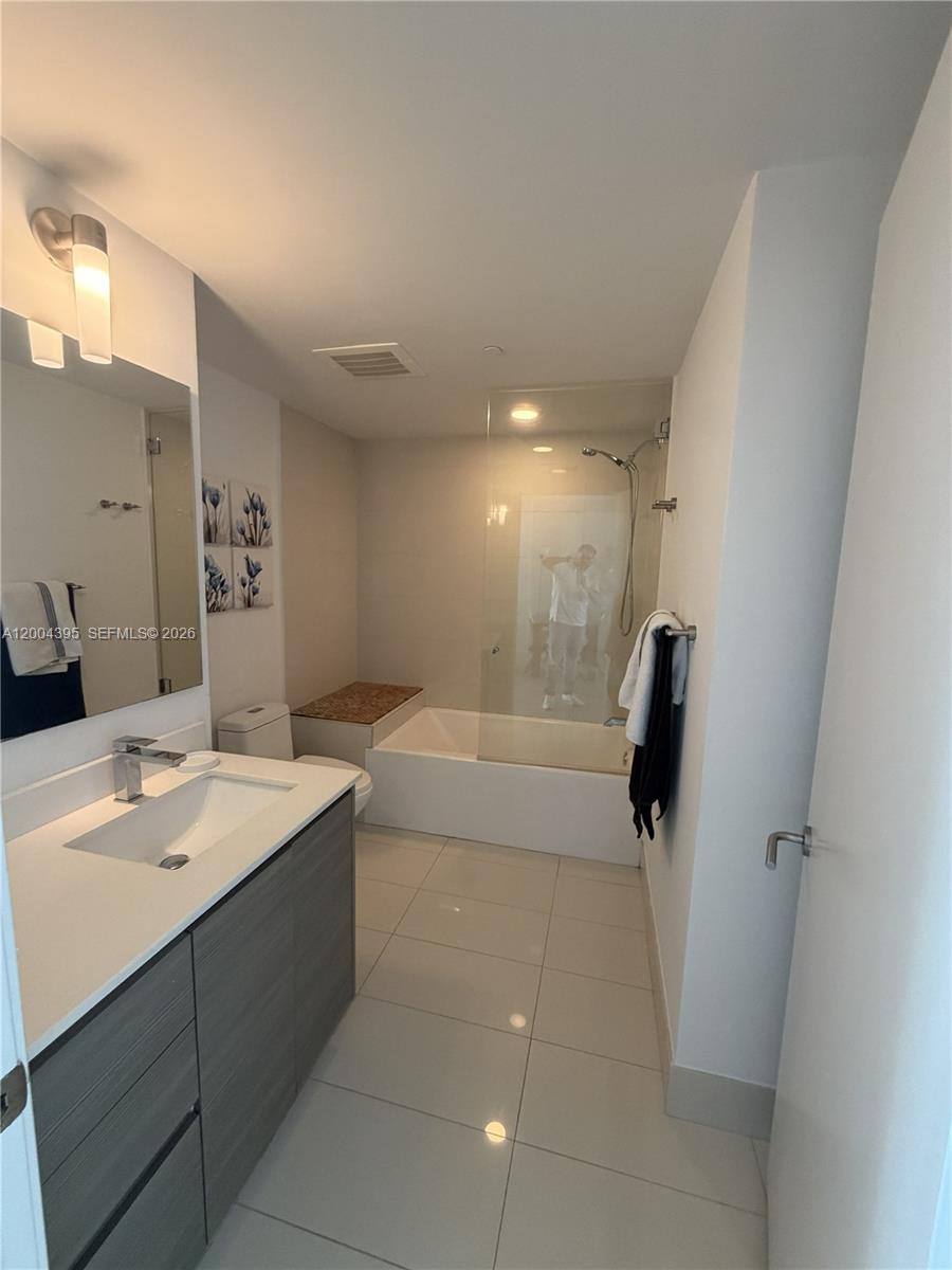 460 Northeast 28th Street, Unit 2806 Miami, FL 33137 - Photo 8 of 10 a bathroom with a sink a toilet and shower