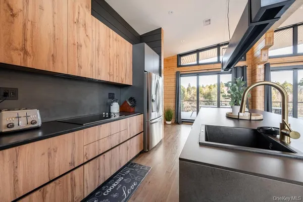 a kitchen with stainless steel appliances granite countertop a sink a stove and cabinets