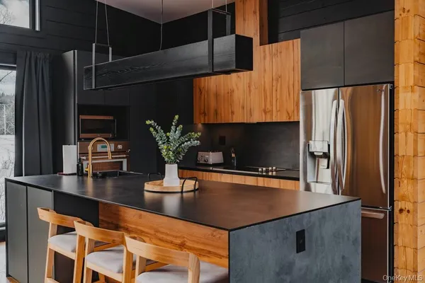 a kitchen with a sink a refrigerator and cabinets
