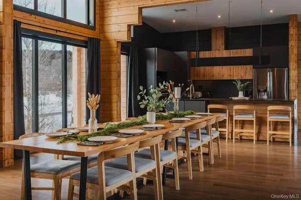 a view of a dining room with furniture window and wooden floor
