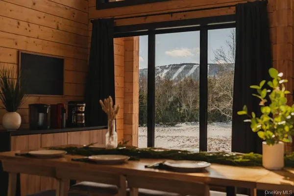 a vase of flowers sitting on a table next to a window