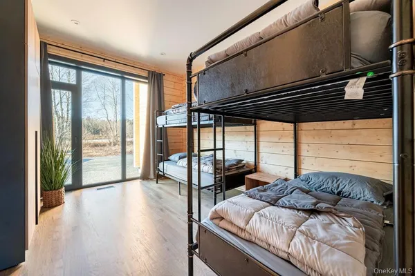 a bedroom with a bed and a large window