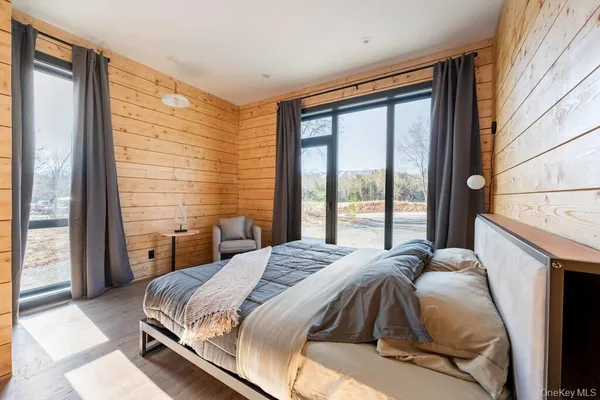 a bedroom with a bed and sliding window