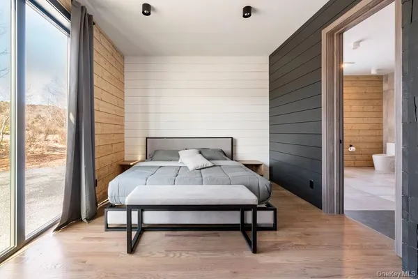 a bathroom with a granite countertop sink a toilet and shower