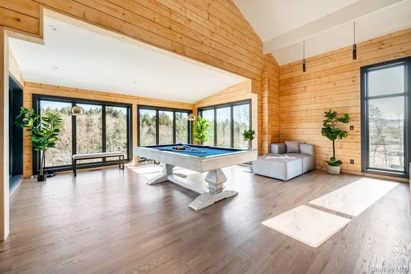 a living room with furniture and a large window with wooden floor