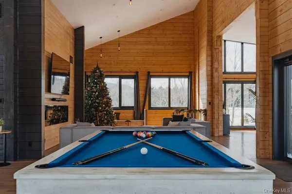 a room with pool table and windows