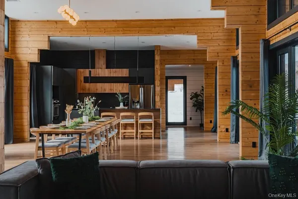 a view of a patio with table and chairs with wooden floor and fence