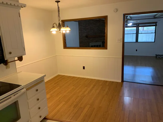 a kitchen with wooden floor and window