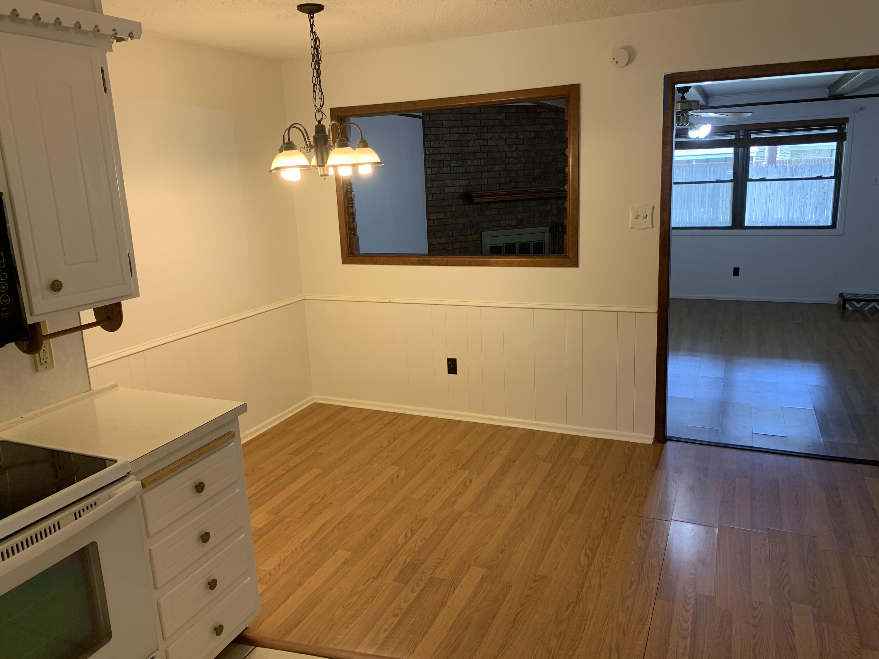 5201 15th Street Lubbock, TX 79416 - Photo 11 of 16 a kitchen with wooden floor and window