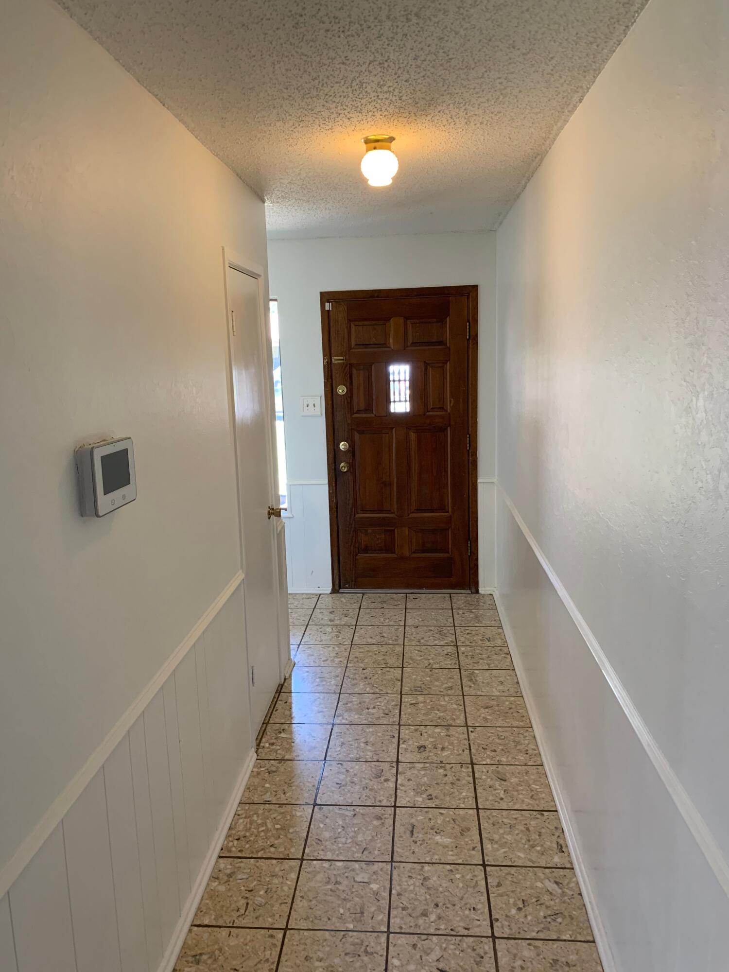 5201 15th Street Lubbock, TX 79416 - Photo 3 of 16 a view of a hallway with wooden floor and a bathroom