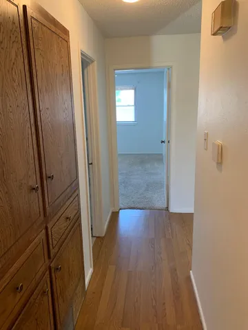 a view of a hallway with wooden floor
