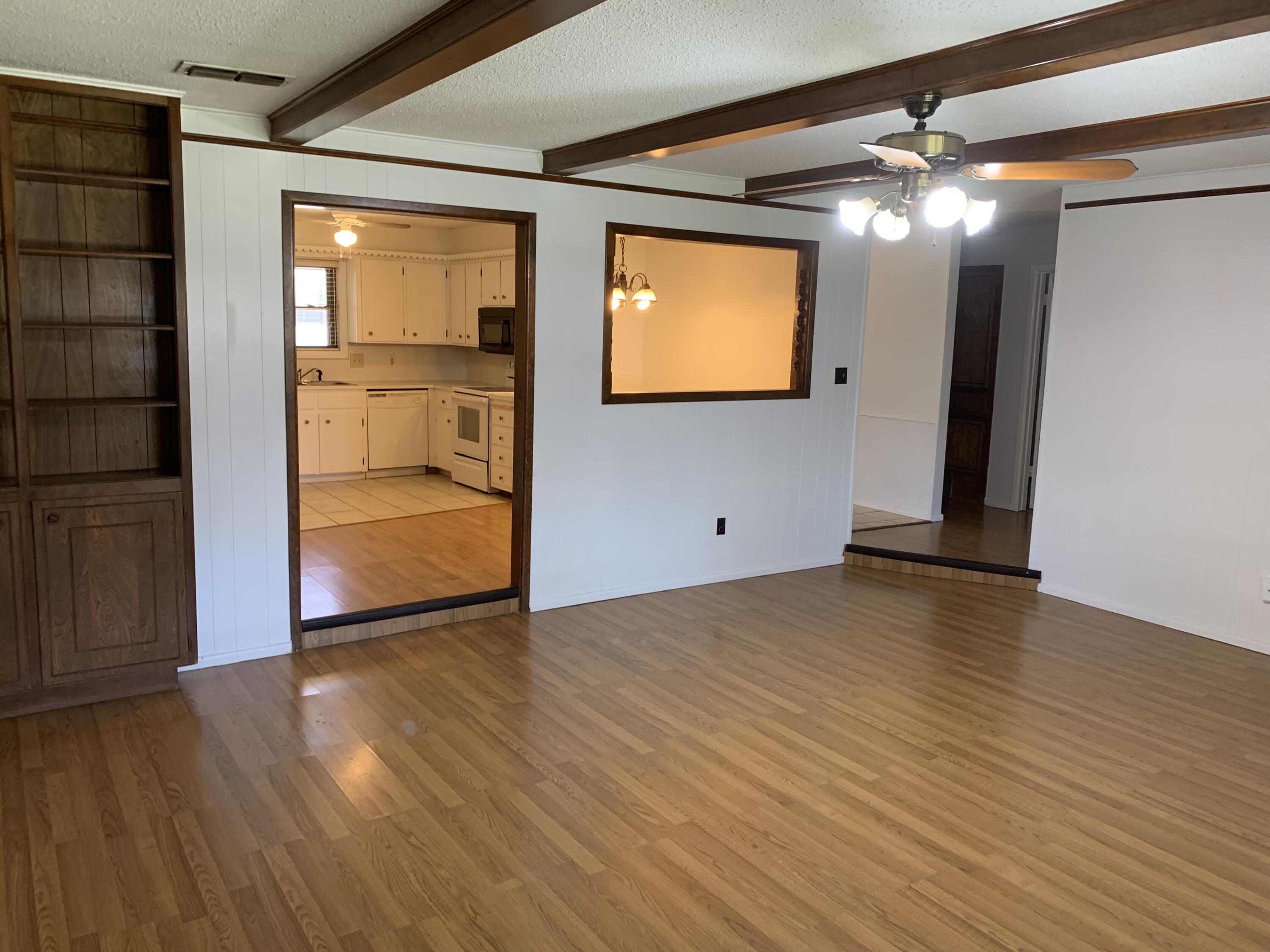 5201 15th Street Lubbock, TX 79416 - Photo 9 of 16 a view of empty room with wooden floor and windows