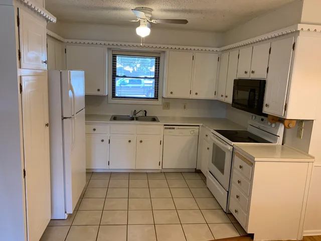 a kitchen with a sink a stove and refrigerator