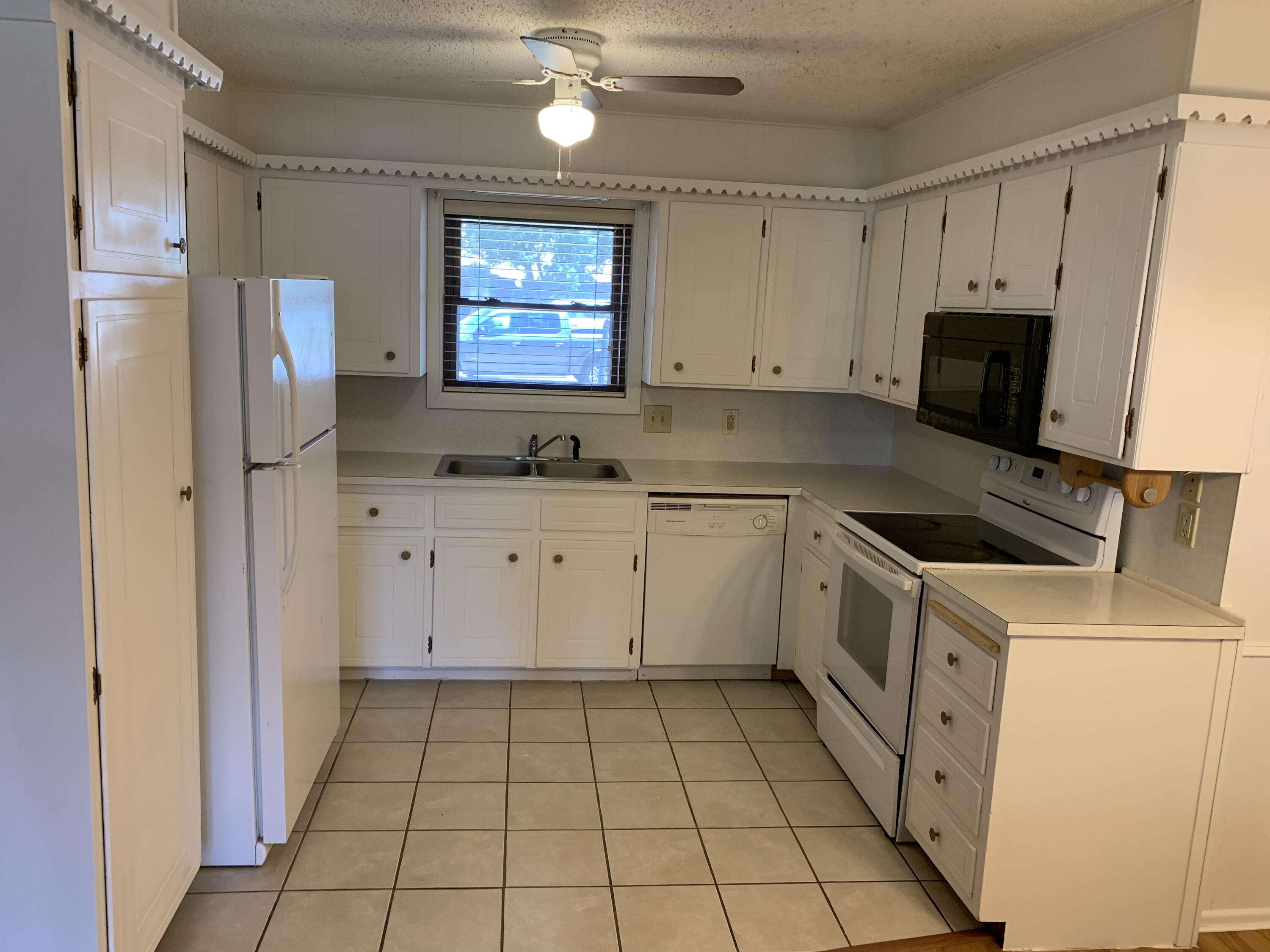5201 15th Street Lubbock, TX 79416 - Photo 10 of 16 a kitchen with a sink a stove and refrigerator